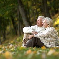 beautiful happy old people sitting in the autumn park